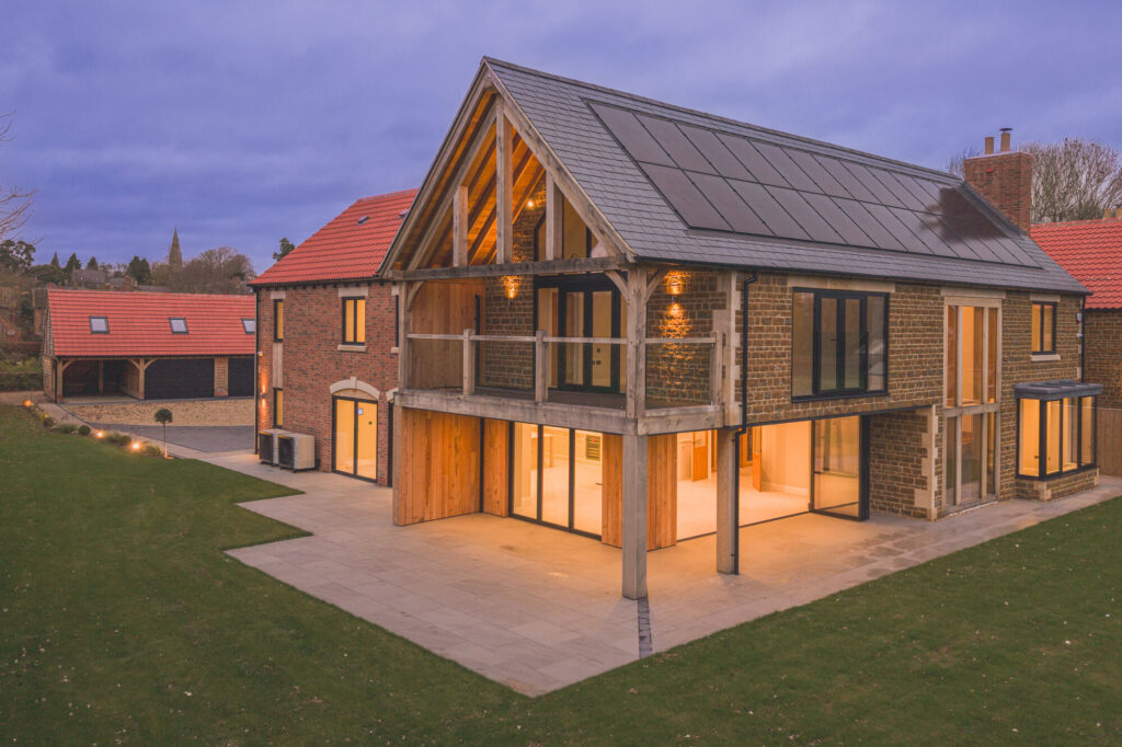 Redwing House, Great Easton — rear elevation at dusk